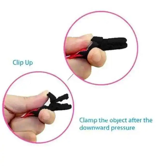 Hand demonstrating small black plastic clip with spring action for clamping objects