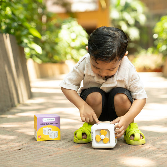 Child playing with a toy on a wooden floor outdoors