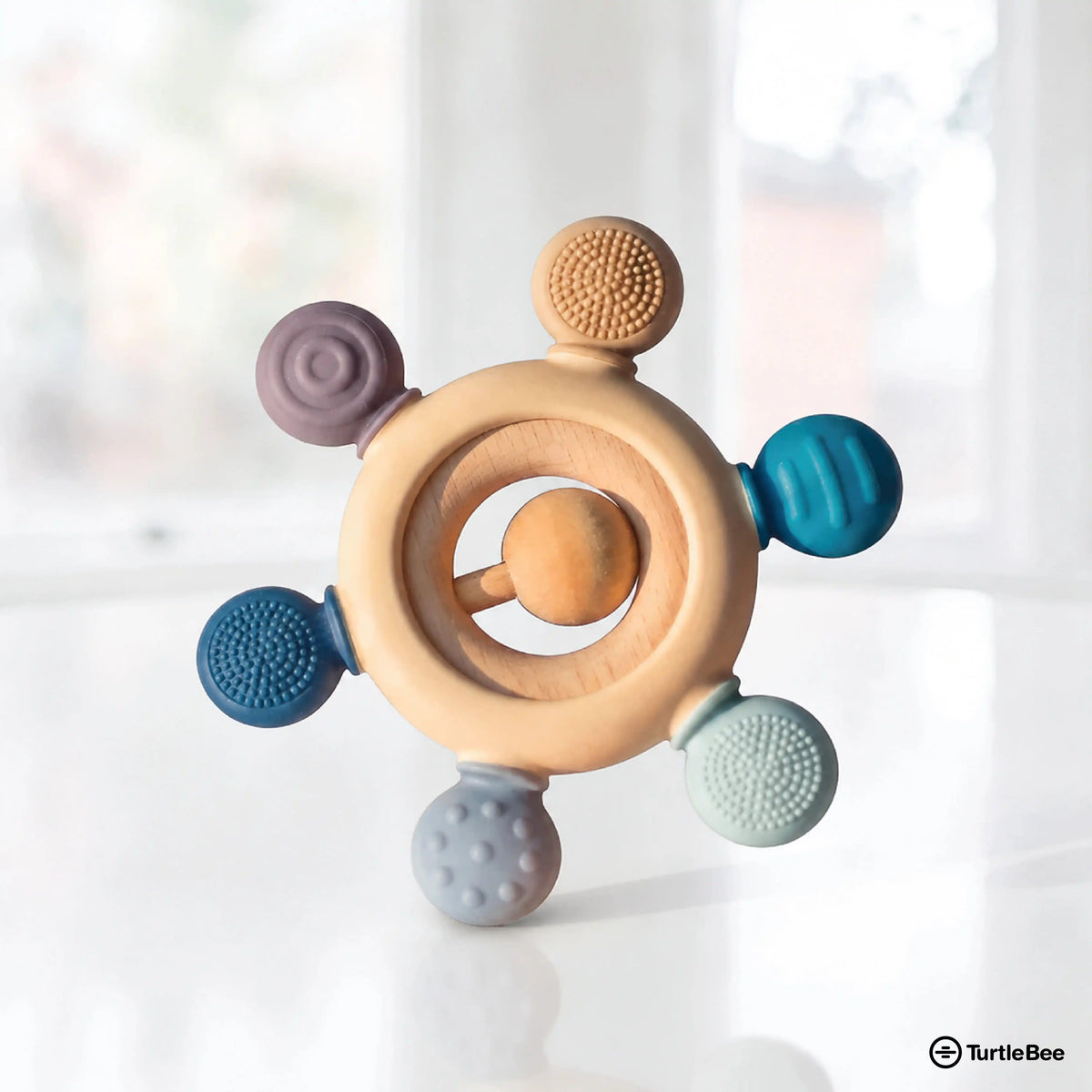 Silicone and wooden teether for infants aged 3-12 months, soft silicone beads and natural wooden elements for soothing gums.